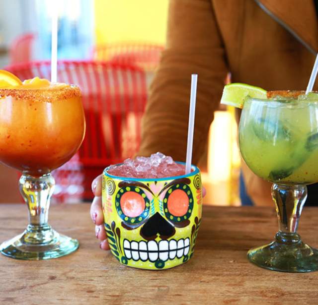 Row of three margaritas with straws