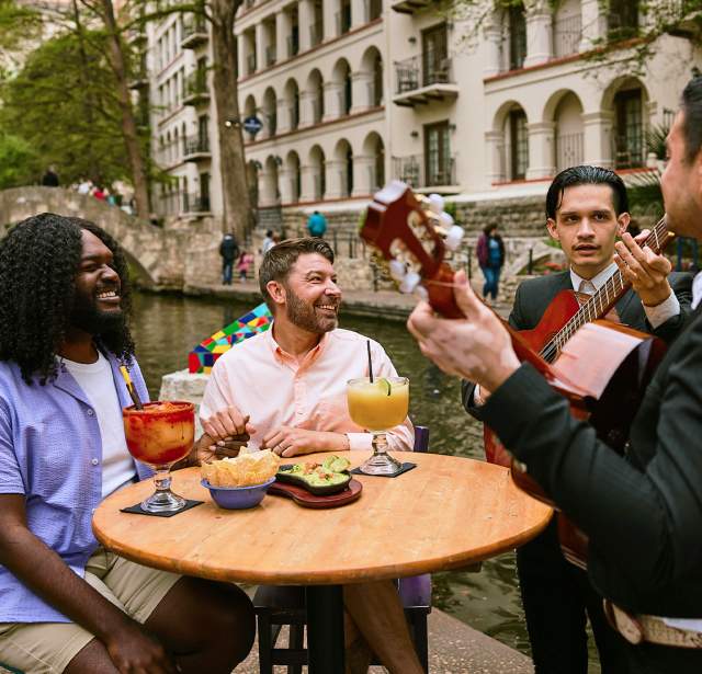 Two mariachi members serenaded two men