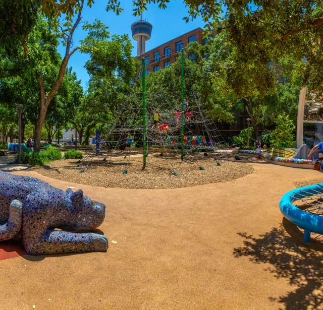 Outdoor play area with Tower of the Americas in the background
