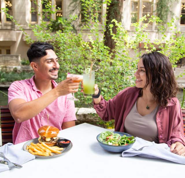 Couple cheers and dines on the San Antonio River Walk