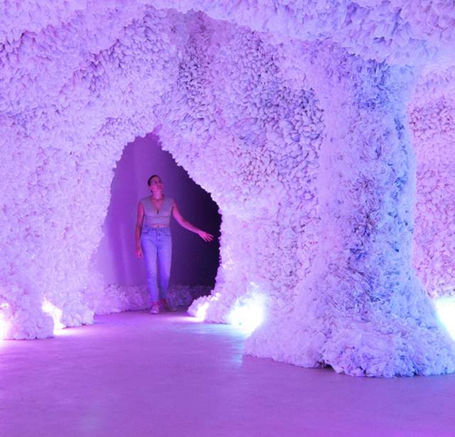 Woman in colorful cave of art