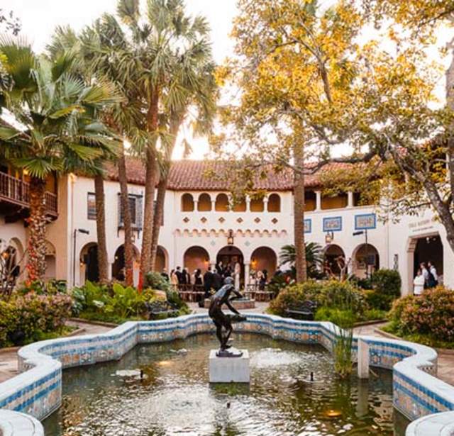 Exterior view of McNay Art Museum with outdoor sculpture and fountain.