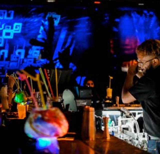 Bartender shaking drinks behind bar