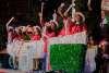 Girls dressed as book character Madeline waving with wands