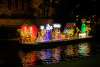 Illuminated chili peppers on river barge