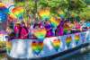 River barge with rainbow hearts and people floating on River Walk
