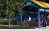 Rendering of people in front of children's train ride.
