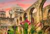 Wooden cross at San Antonio Missions National Historical Park with pink sky in background.