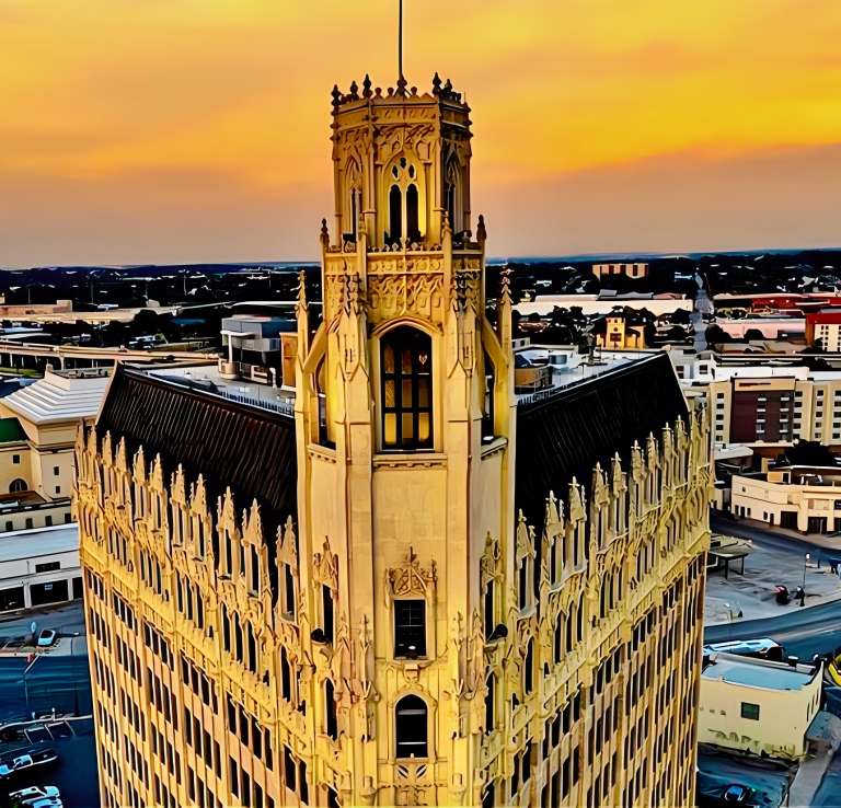 Overhead view of Emily Morgan Hotel in San Antonio with skyline in the background.
