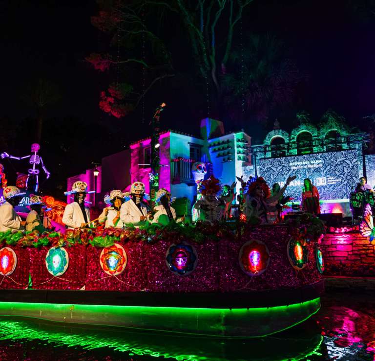 Vibrant float on the River Walk decorated for Day of the Dead celebrations.