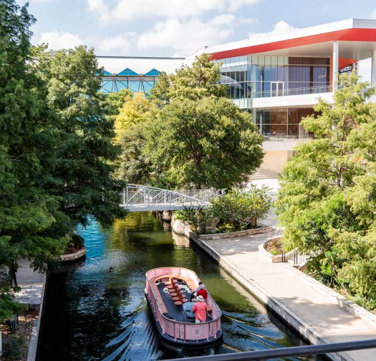 View of exterior Henry B. Gonzalez Convention Center building overlooking the San Antonio River Walk.