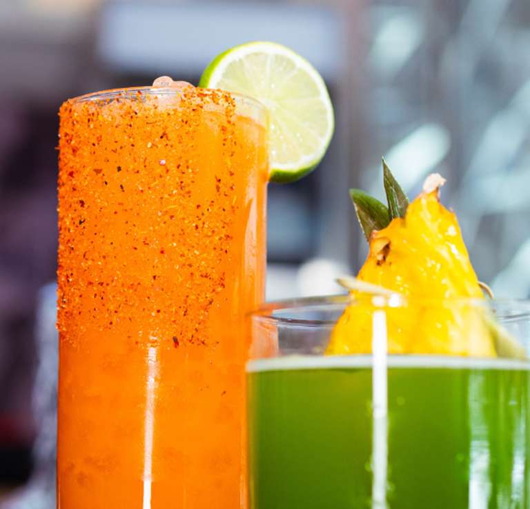 Two tropical cocktails side-by-side.