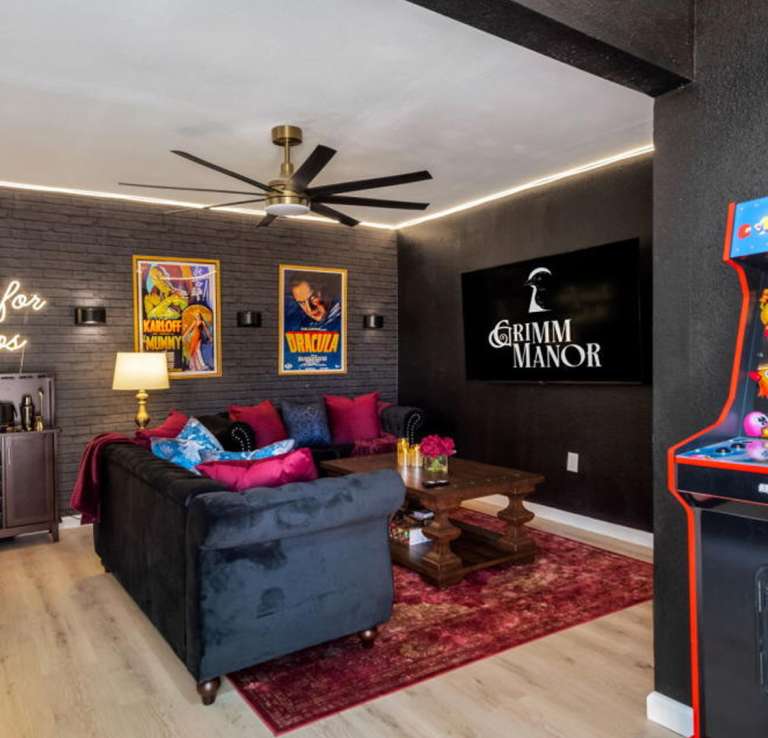 Vacation rental with Pac-Man game and living room in background.