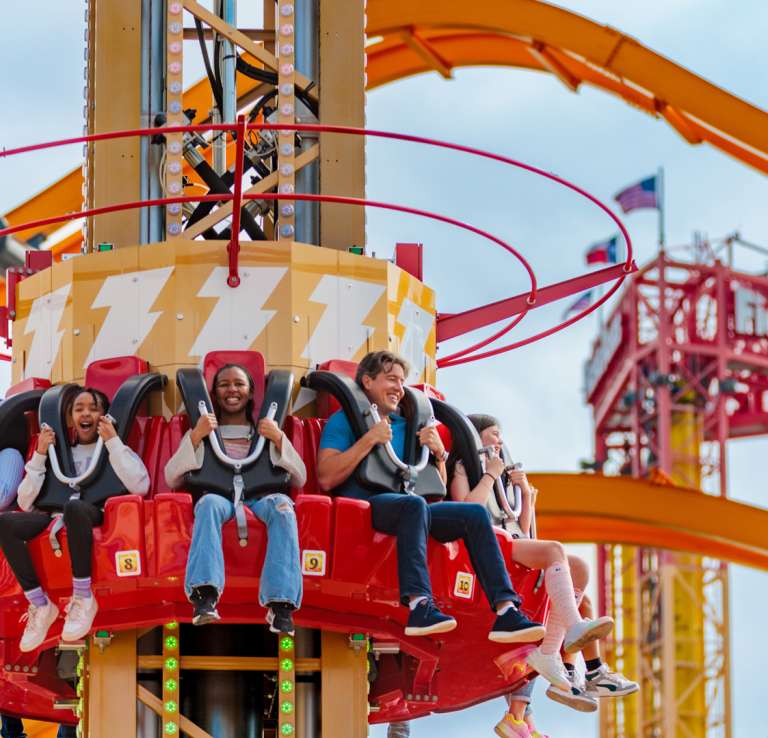 People on Shazam-themed drop tower ride at Six Flags Fiesta Texas.