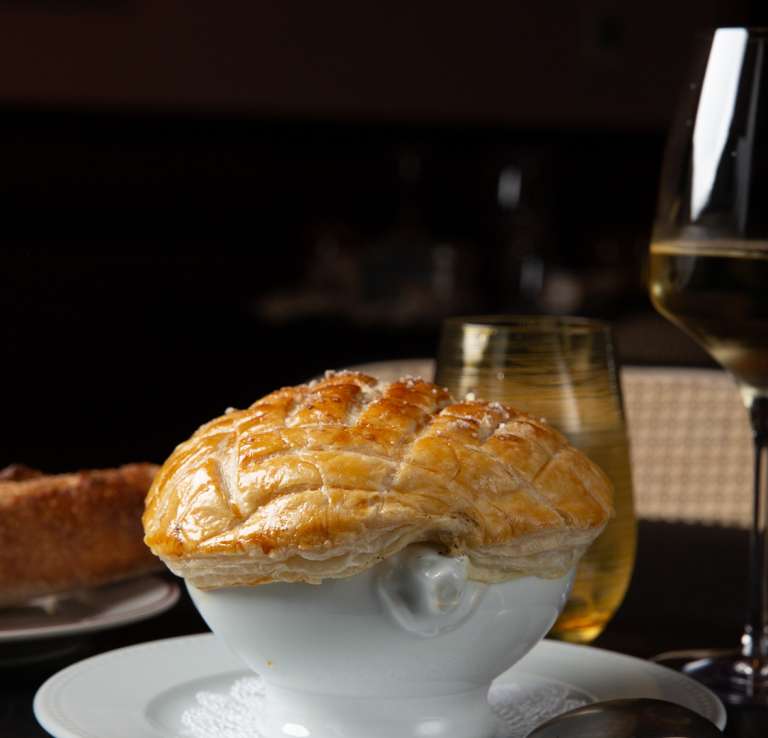 Bowl next to bread and wine glass