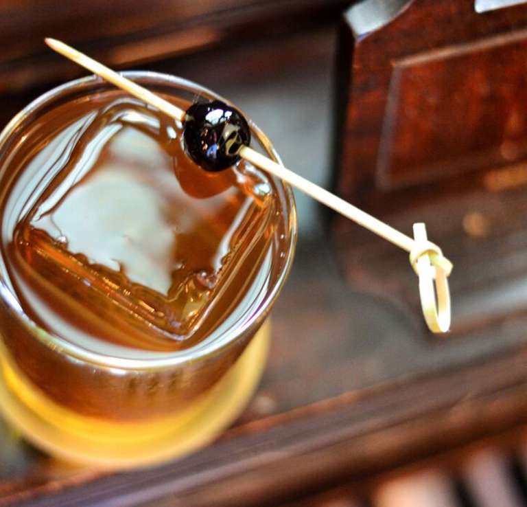 Overhead view of old fashioned with square ice cube