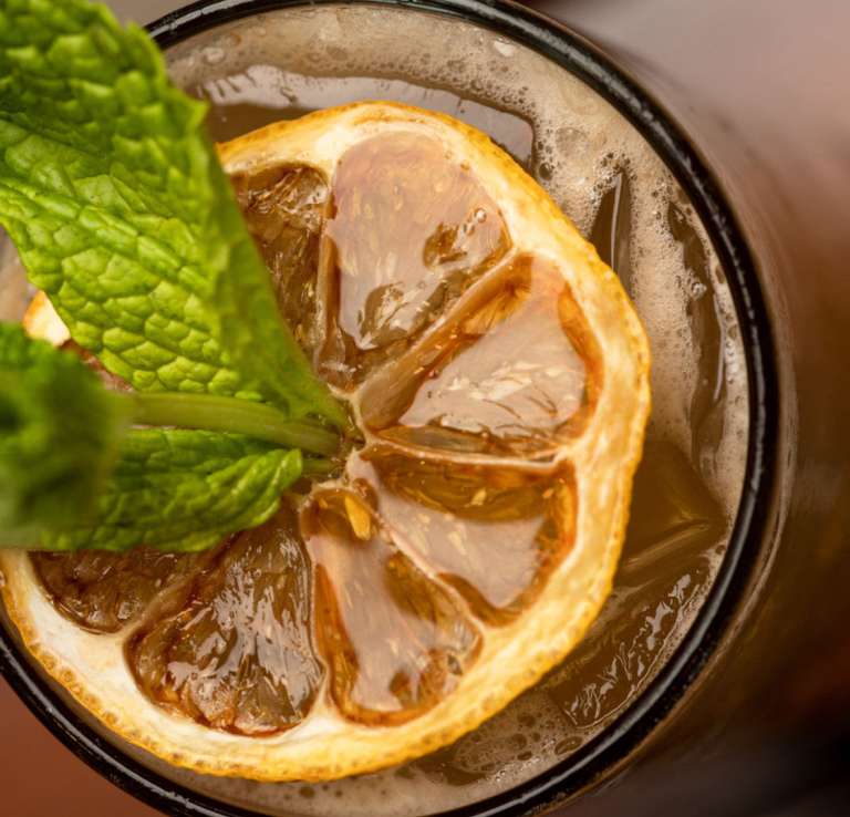 Adult beverage with greenery as garnish