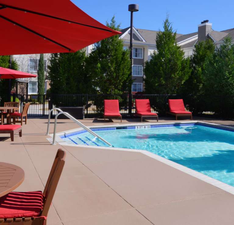 Hotel pool with red lounge furniture
