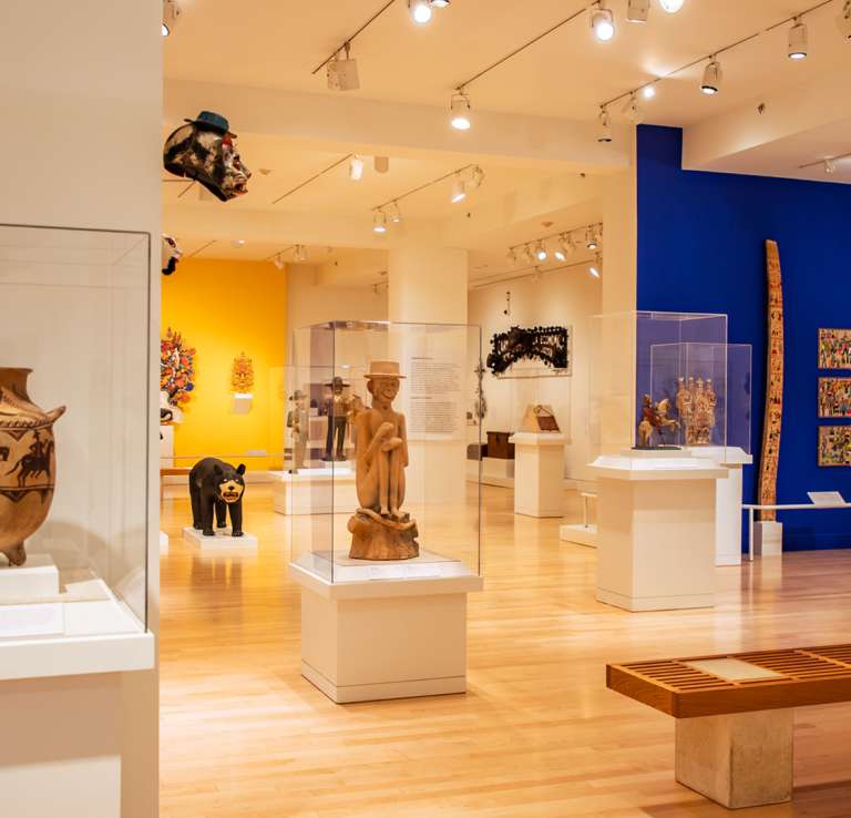 Art gallery room with displays under protective glass