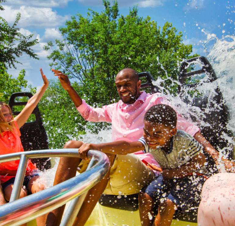 Family on circular ride being splashed