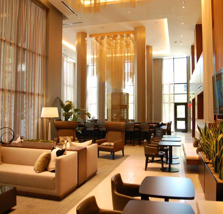 Tables and chairs in lounge area of AC Marriott.