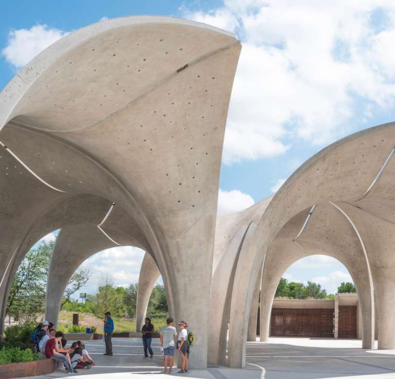 Domes at confluence park with people walking beneath them.