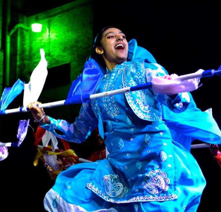 Costumed performers at DiwaliSA with multicolored performance pieces.