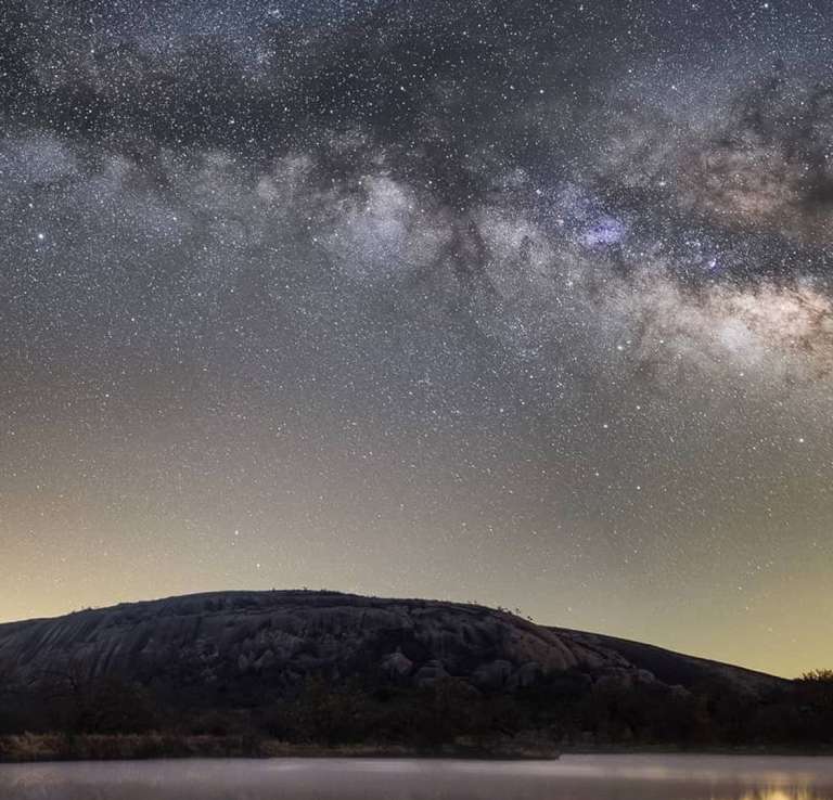 Starry night sky over hills
