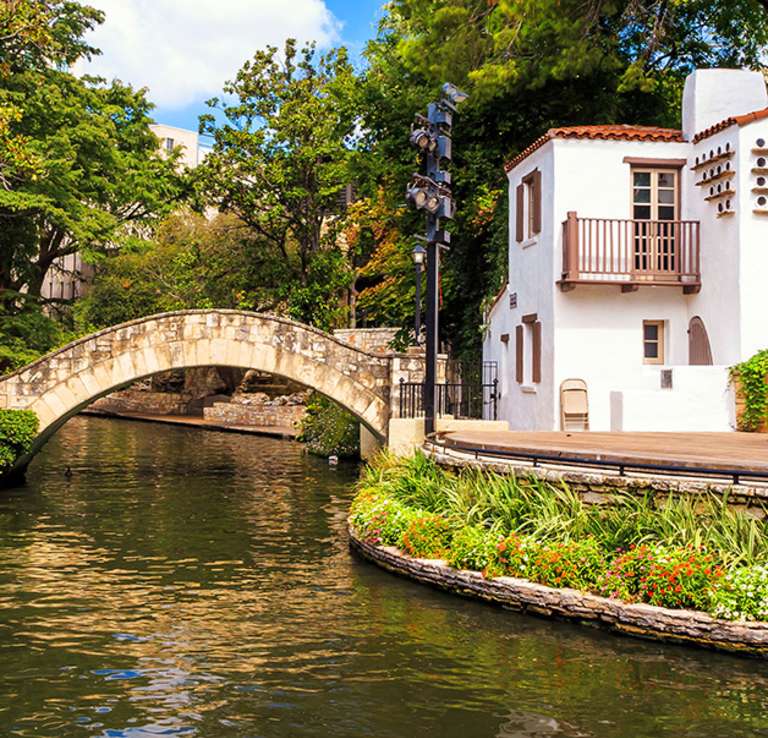 Water flowing under bridge at River Walk in front of Arneson River Theatre.