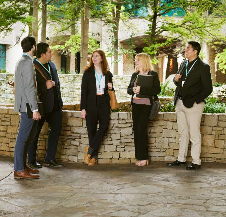 Group of meeting professionals gathering in front of grotto at Henry B.Gonzalez Convention Center