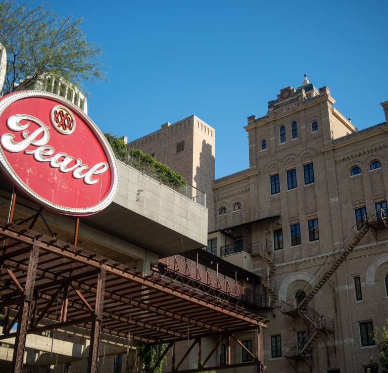 Pearl building exterior on clear day.