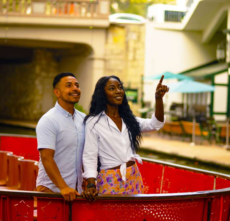 Couple on a Go Rio Barge on the River Walk smiling