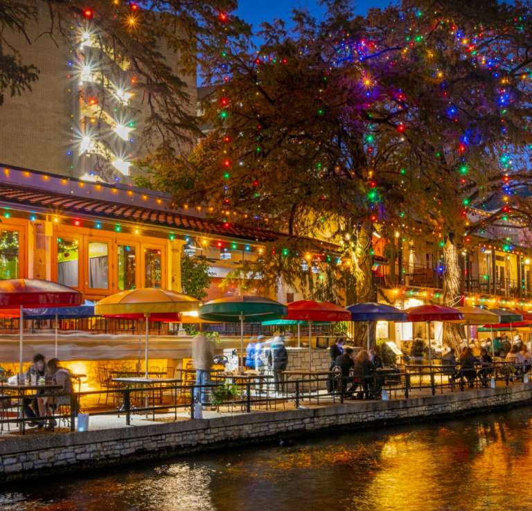 River Walk view with holiday lights adorned on trees