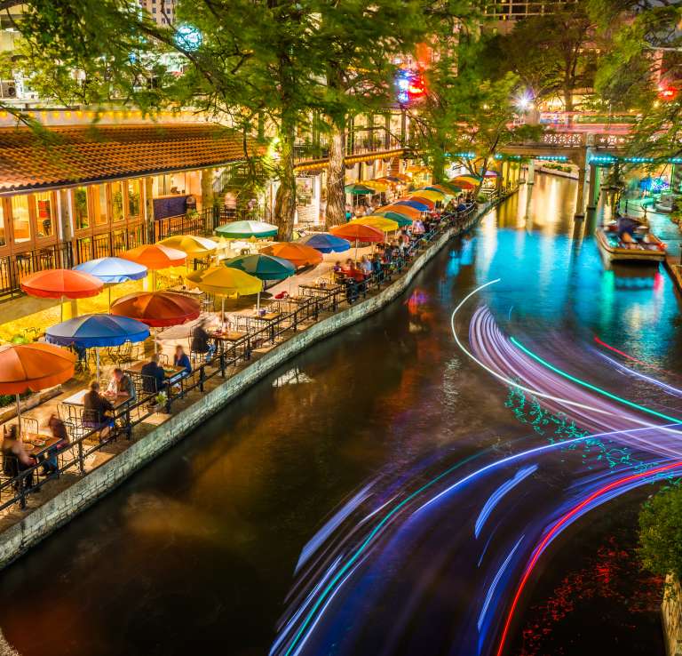 River Walk pathway lit with colorful umbrellas