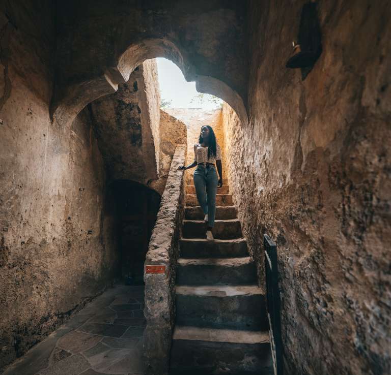 Woman walking down stairs at San Antonio Missions National Historical Park.