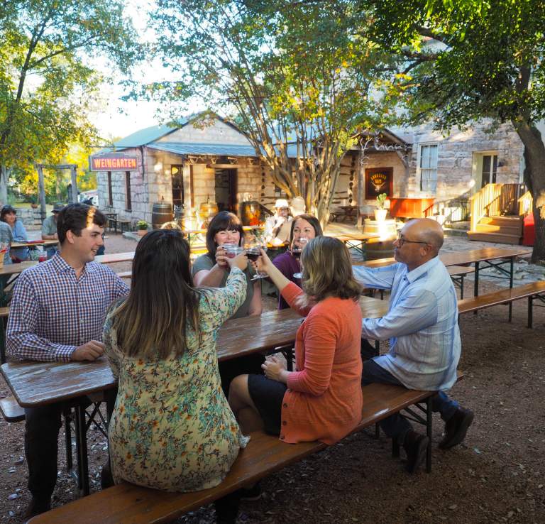 Group of people sitting at table making a toast