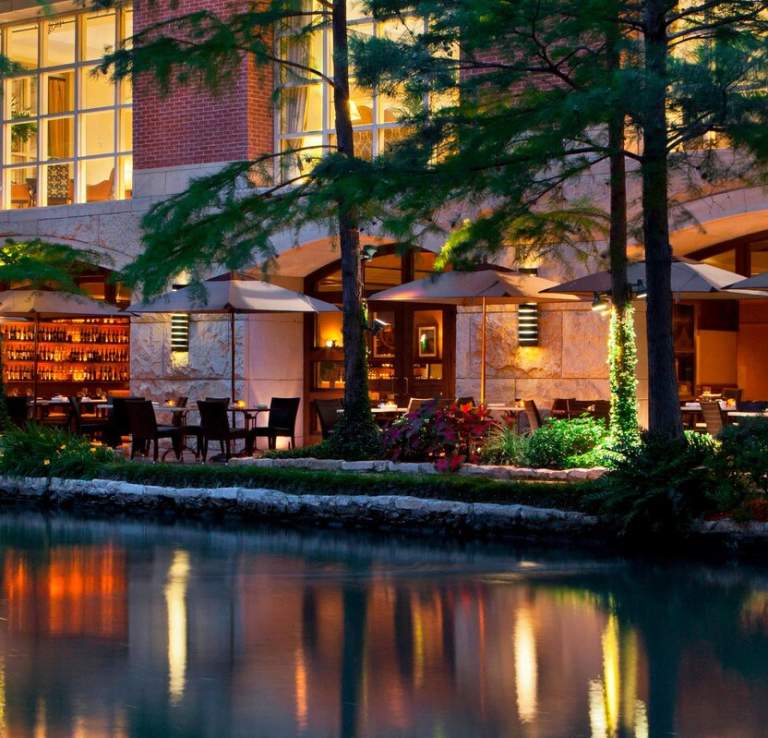 Umbrellas lit up at night on River Walk