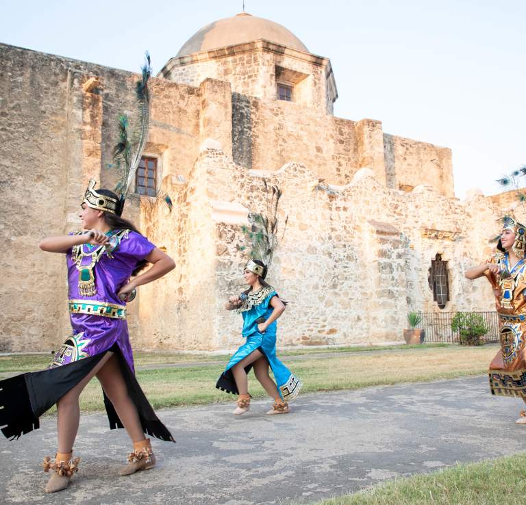 Performer smiling at San Antonio Missions National Historical Park.