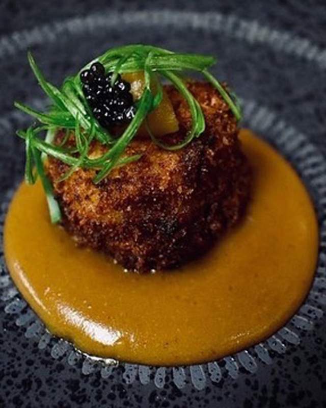 Appetizer surrounded by sauce