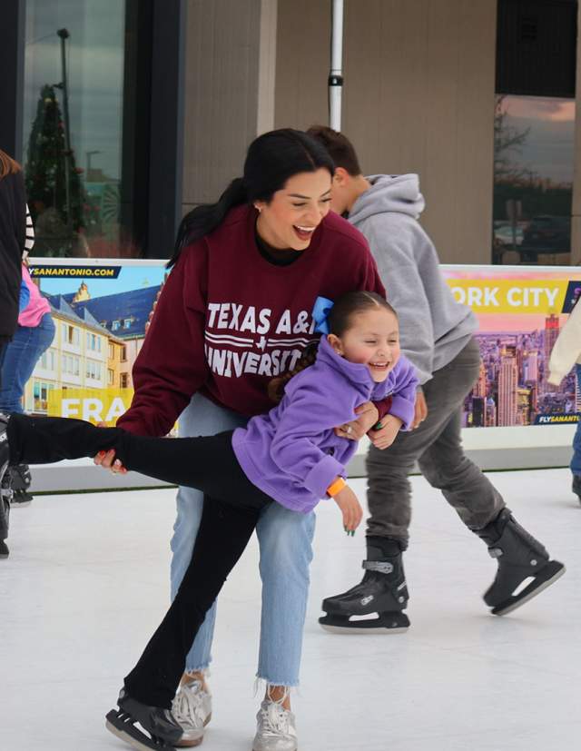 Mother at daughter ice skating at ice rink at The Rock at La Cantera in San Antonio.
