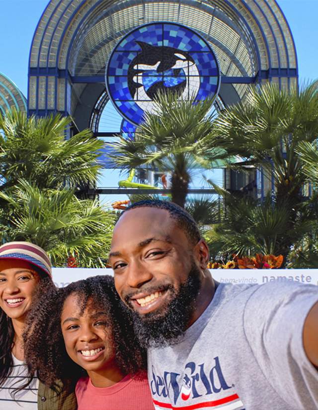 Family taking selfie in front of SeaWorld San Antonio arches