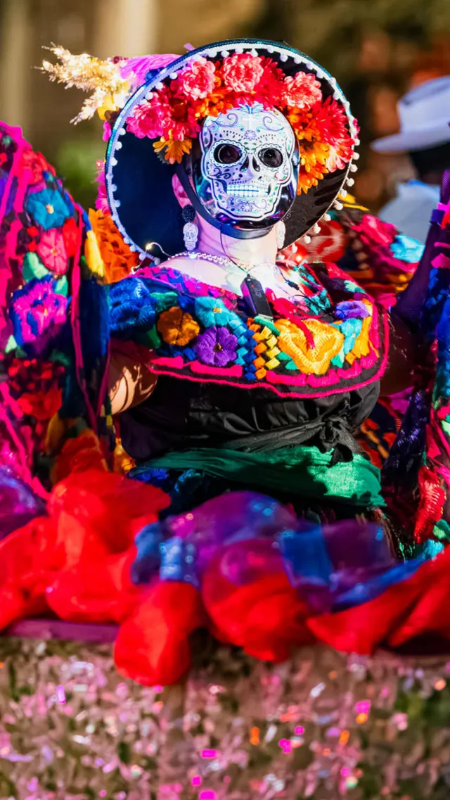 Performer in sugar skull mask at Day of the Dead event in San Antonio.