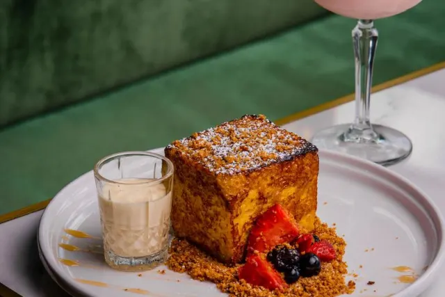 Pastry next to glass of sweet drink