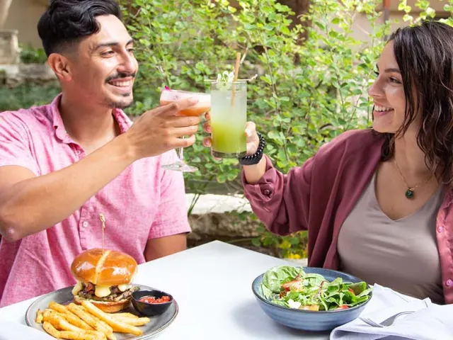 Man and woman toasting each other at the San Antonio River Walk