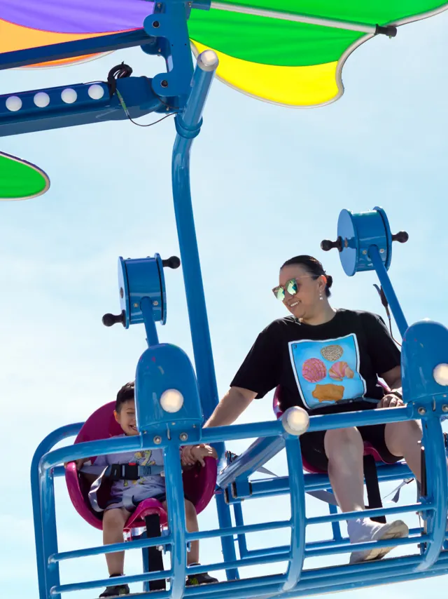 Riders on hang glide ride