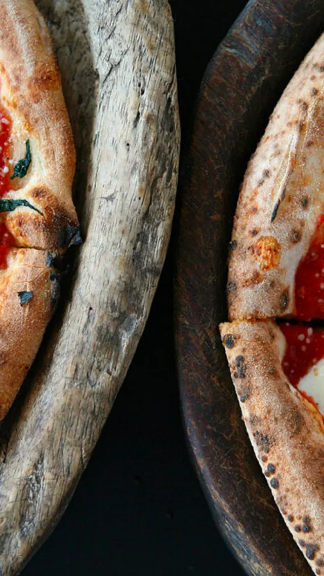 Overhead view of two pizzas side by side.