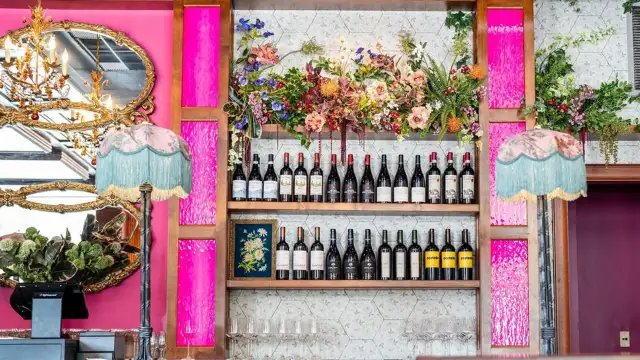 Two shelves full of wine bottles