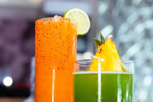 Two tropical cocktails side-by-side.