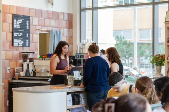 people at register at a coffee shop