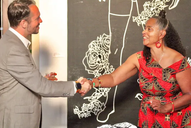 Woman shaking man's hand at San Antonio Black International Film Festival.